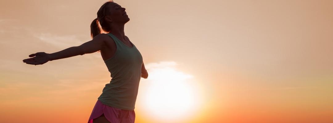 Woman embracing a sunset