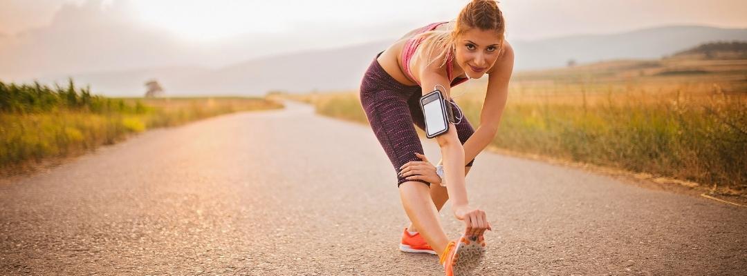 A girl exercising and stretching on the road